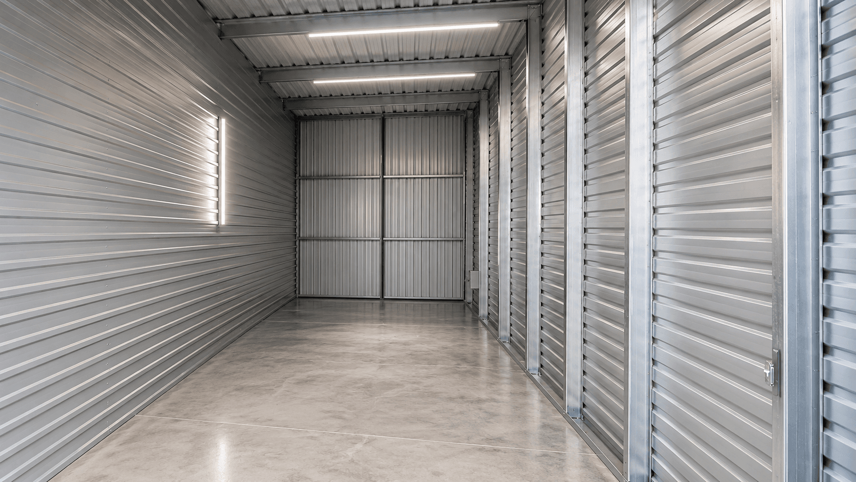 Interior view of a Modern Storage® large commercial storage unit with corrugated steel walls and bright LED lighting — sized for warehouse-style storage
