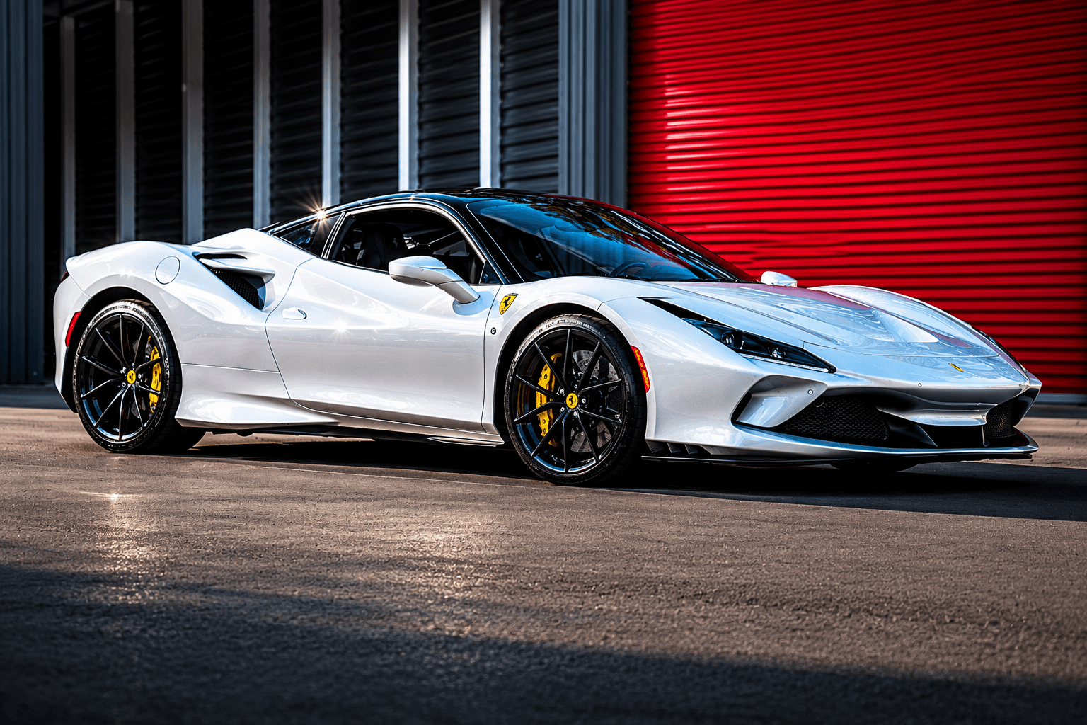 Ferrari beside a red Modern Storage® roll-up door — Arkansas exotic and classic car storage