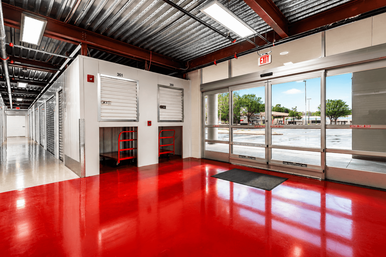 Climate-controlled storage entrance with sealed red floor inside Modern Storage® Riverdale in Little Rock