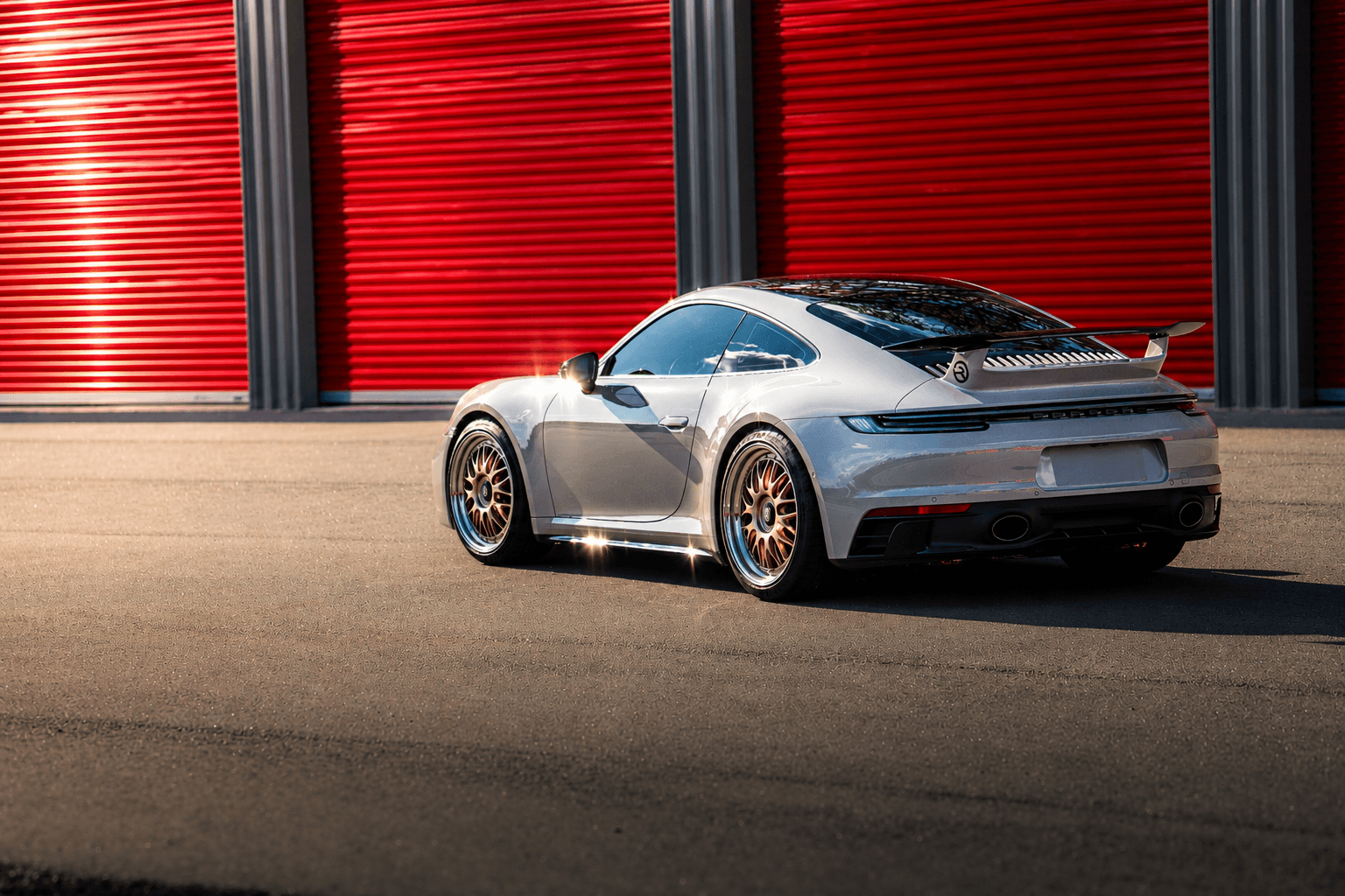 Porsche GTS parked beside a Modern Storage® unit — indoor enclosed vehicle storage in Arkansas