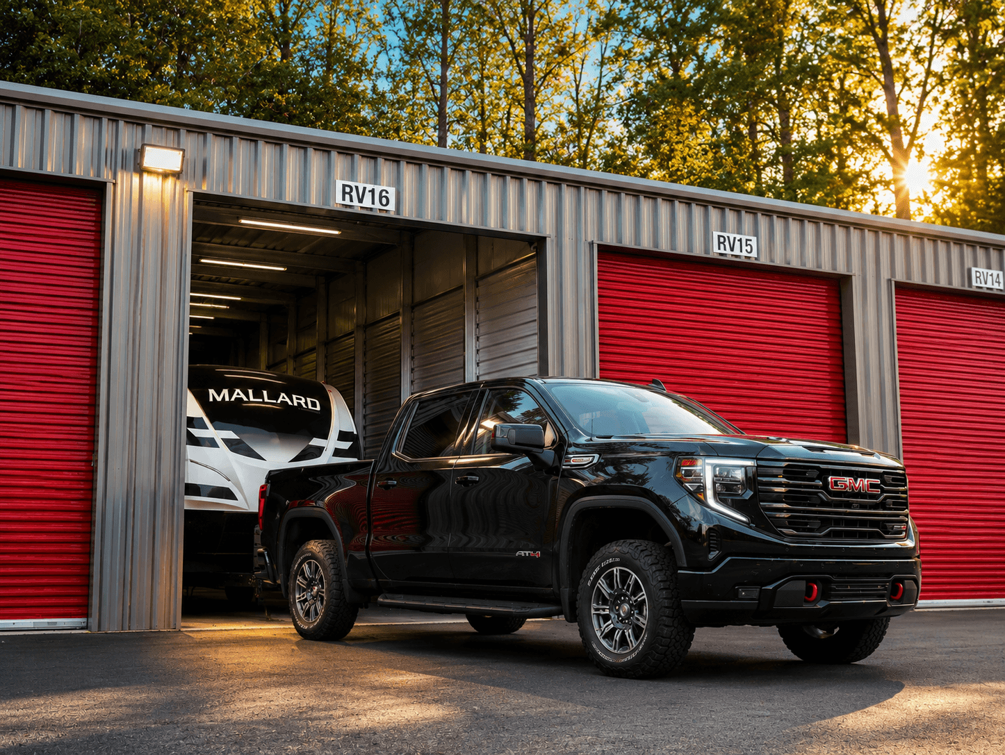 Tow truck and travel trailer at a Modern Storage® drive-up RV storage unit at sunset — boat, RV, and vehicle storage in Arkansas