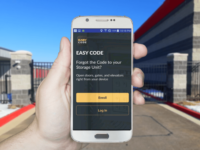 Modern Storage® Bentonville gate access app shown on a smartphone at the facility's security gate