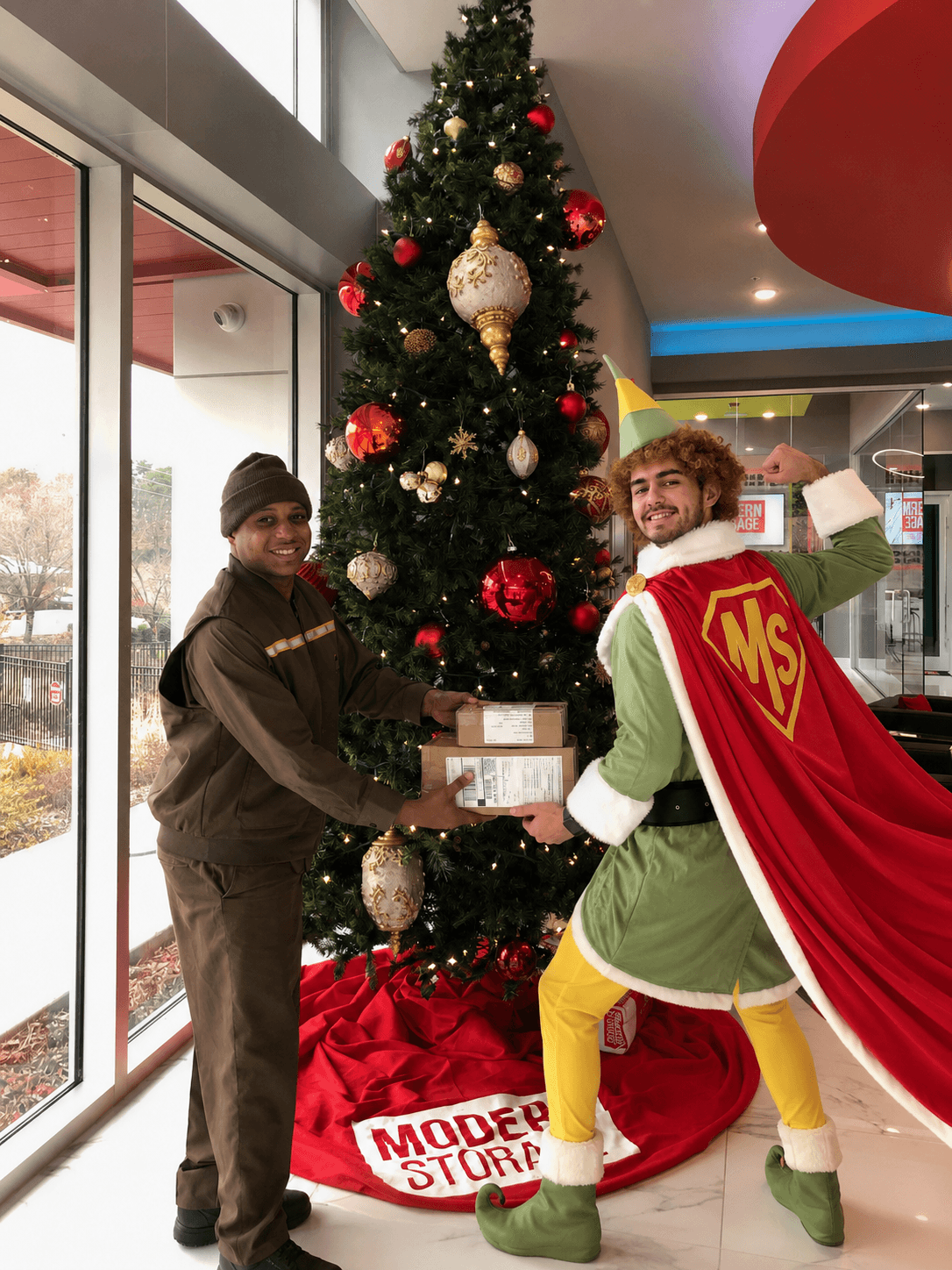 UPS driver handing holiday packages to a superhero elf at Modern Storage during the Christmas season.