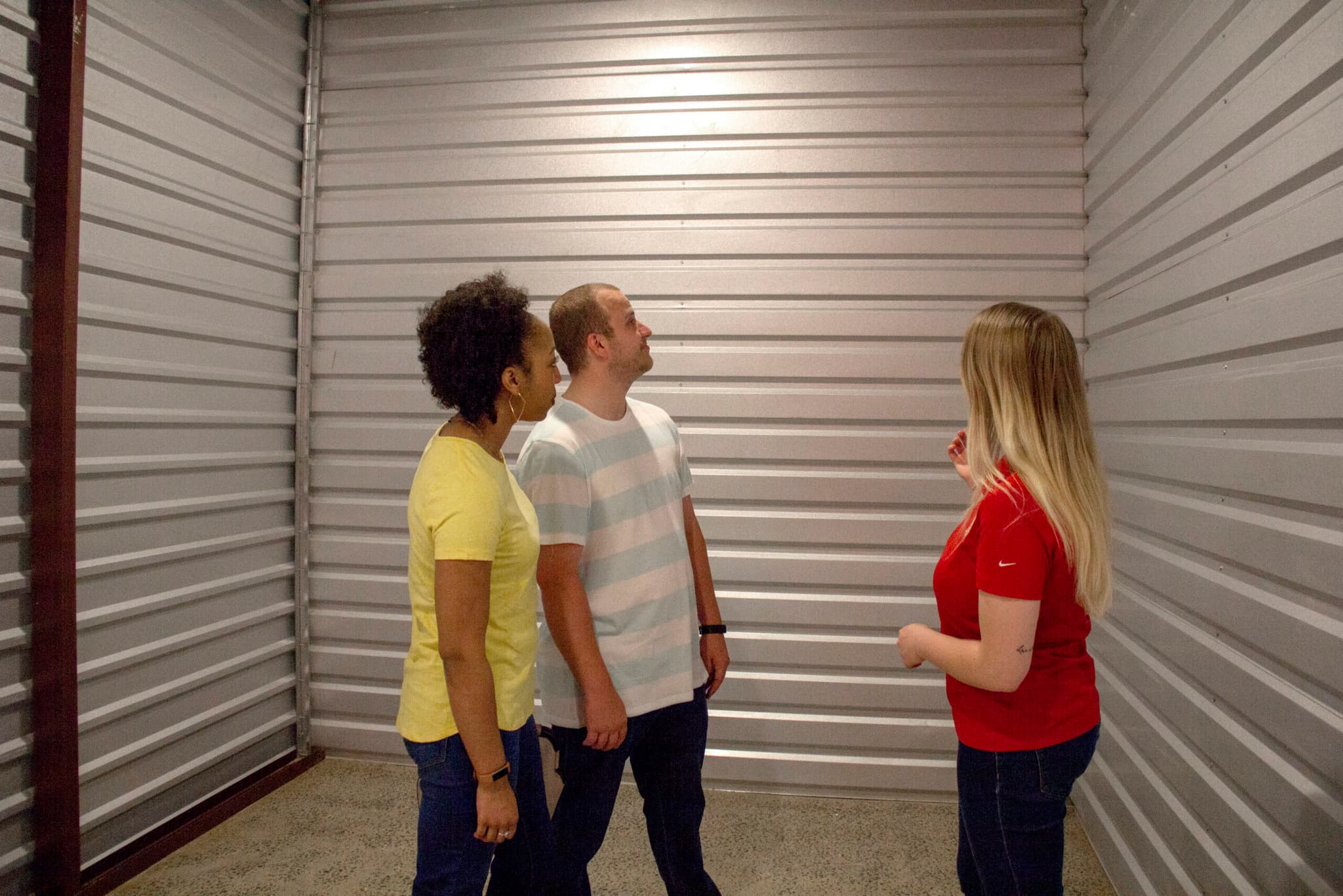 Two women standing in front of a Modern Storage® unit, talking and smiling during a move-in.
