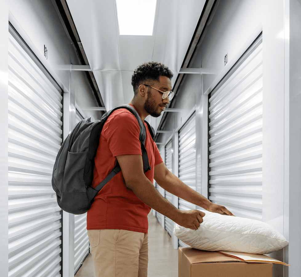 Customer moving belongings into a clean, climate-controlled storage unit at Modern Storage.