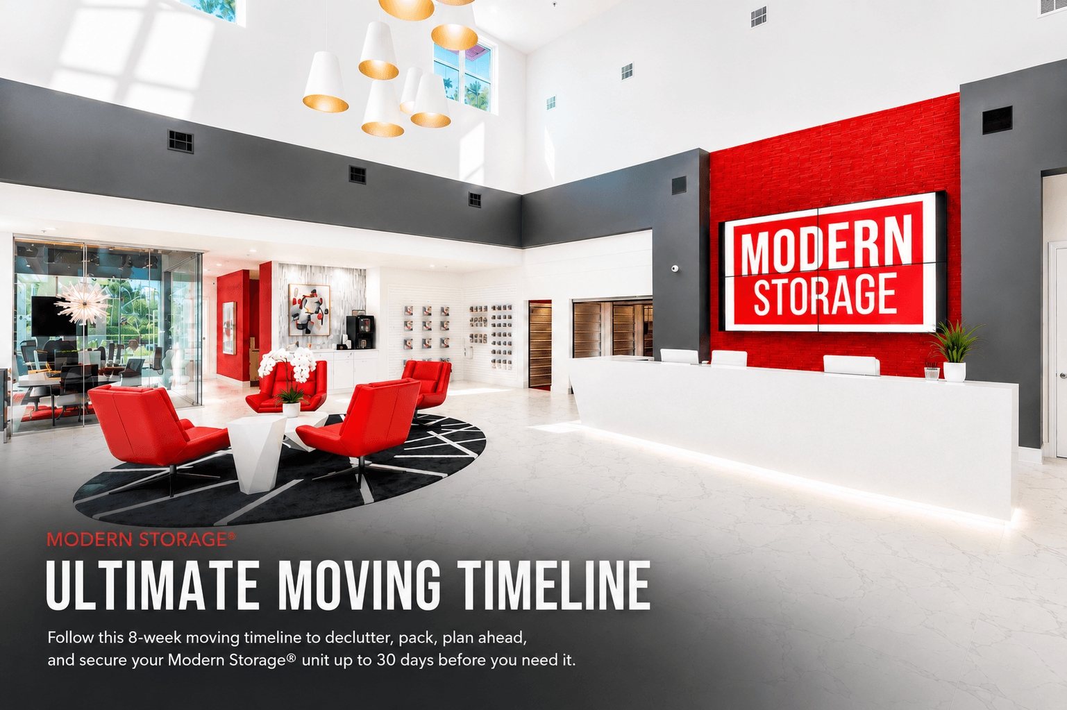 Bright, modern Modern Storage® lobby with red lounge chairs, a white reception desk, and a large illuminated logo behind the moving timeline text.