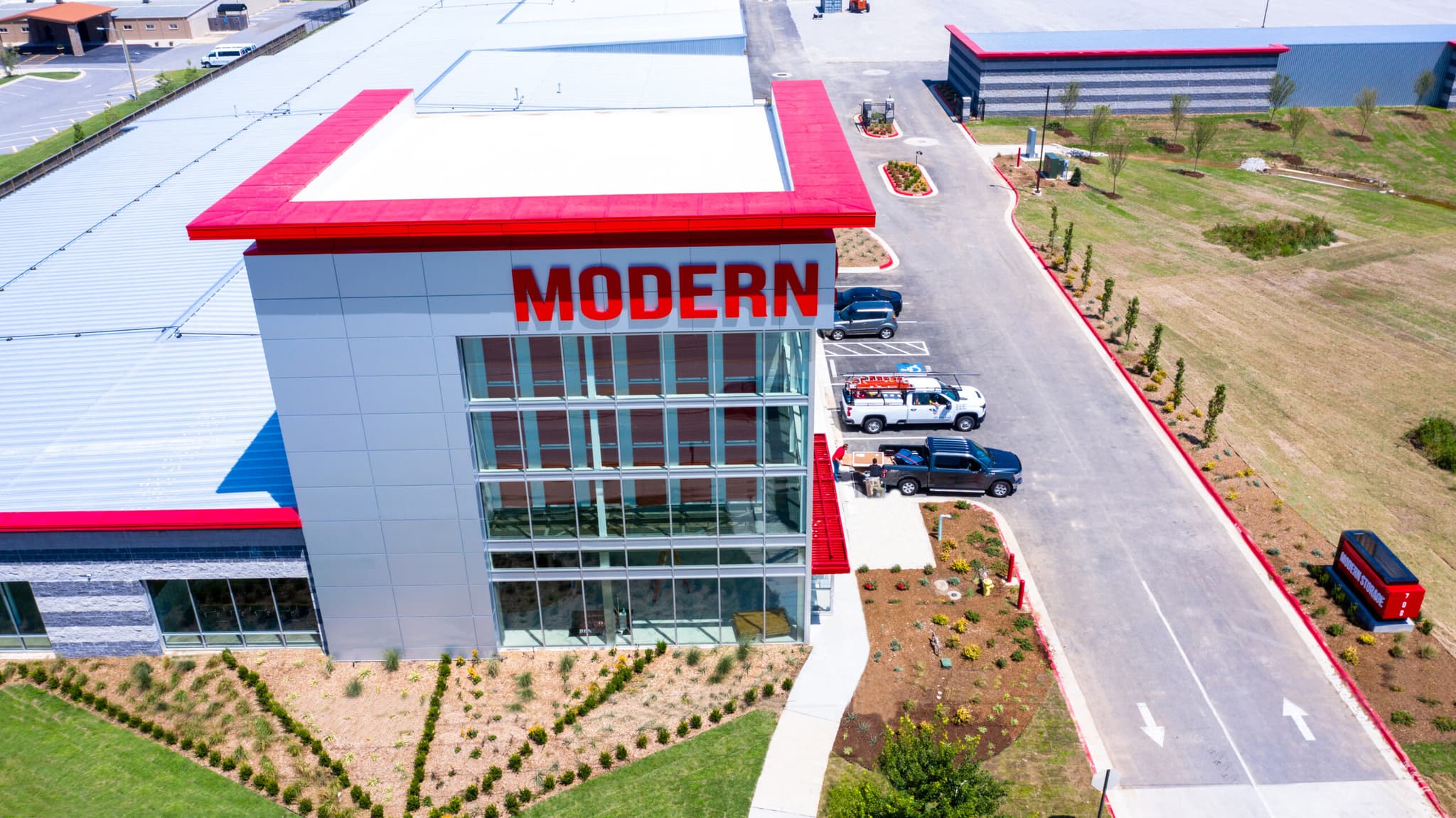 Aerial view of the Modern Storage® Bentonville facility featuring gated access, modern architecture, and easy parking for cus