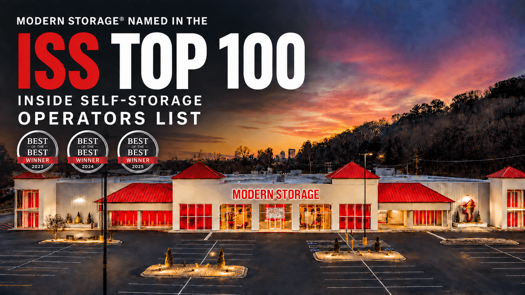 Modern Storage facility illuminated at sunset with red doors and Modern Storage signage