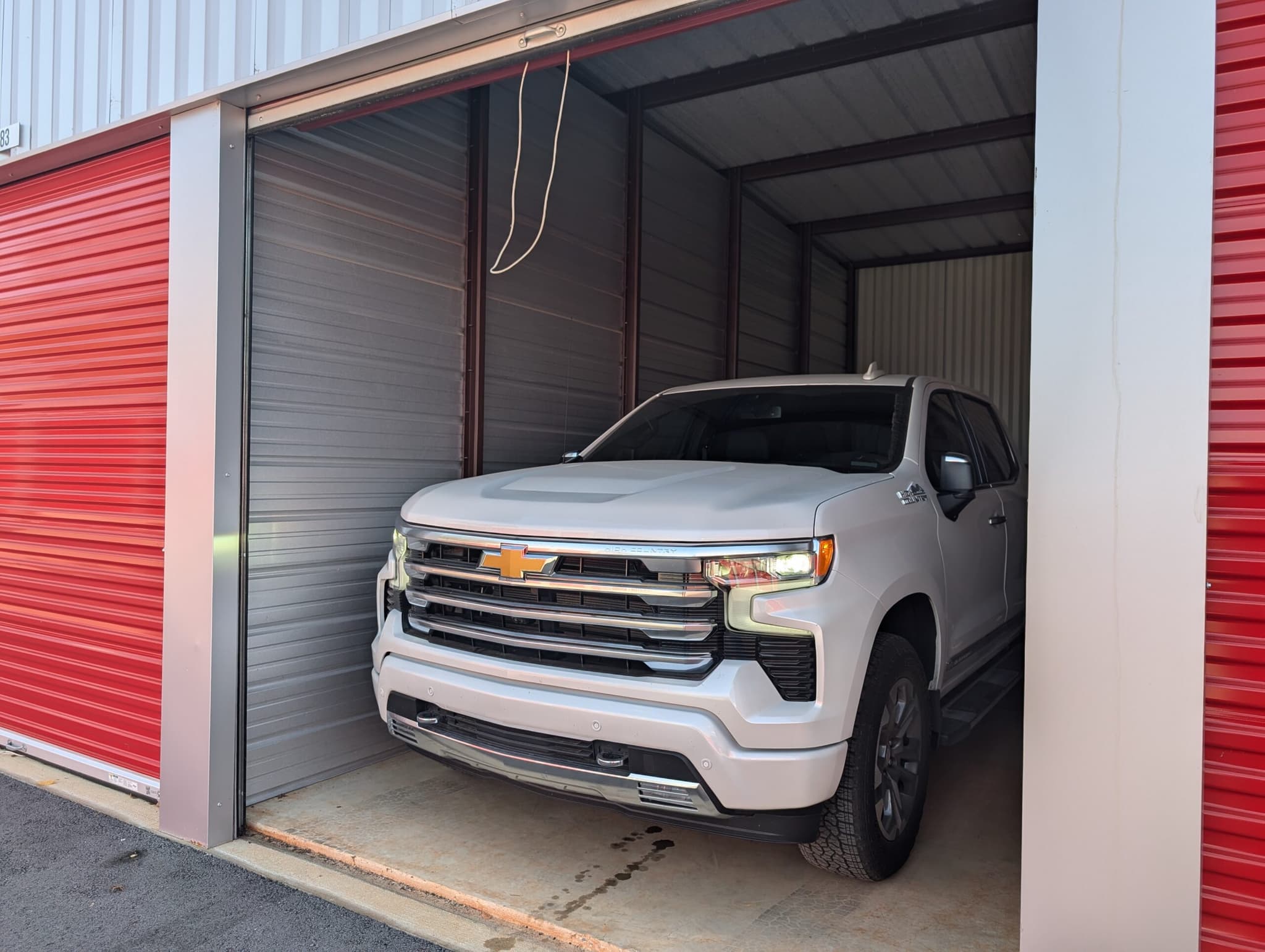 White SUV parked inside a secure indoor vehicle storage unit at Modern Storage® Springdale
